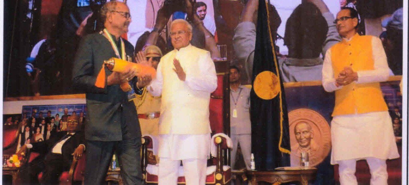 Dr. Prakash Jain receiving the Champions of Change Madhya Pradesh award on stage
